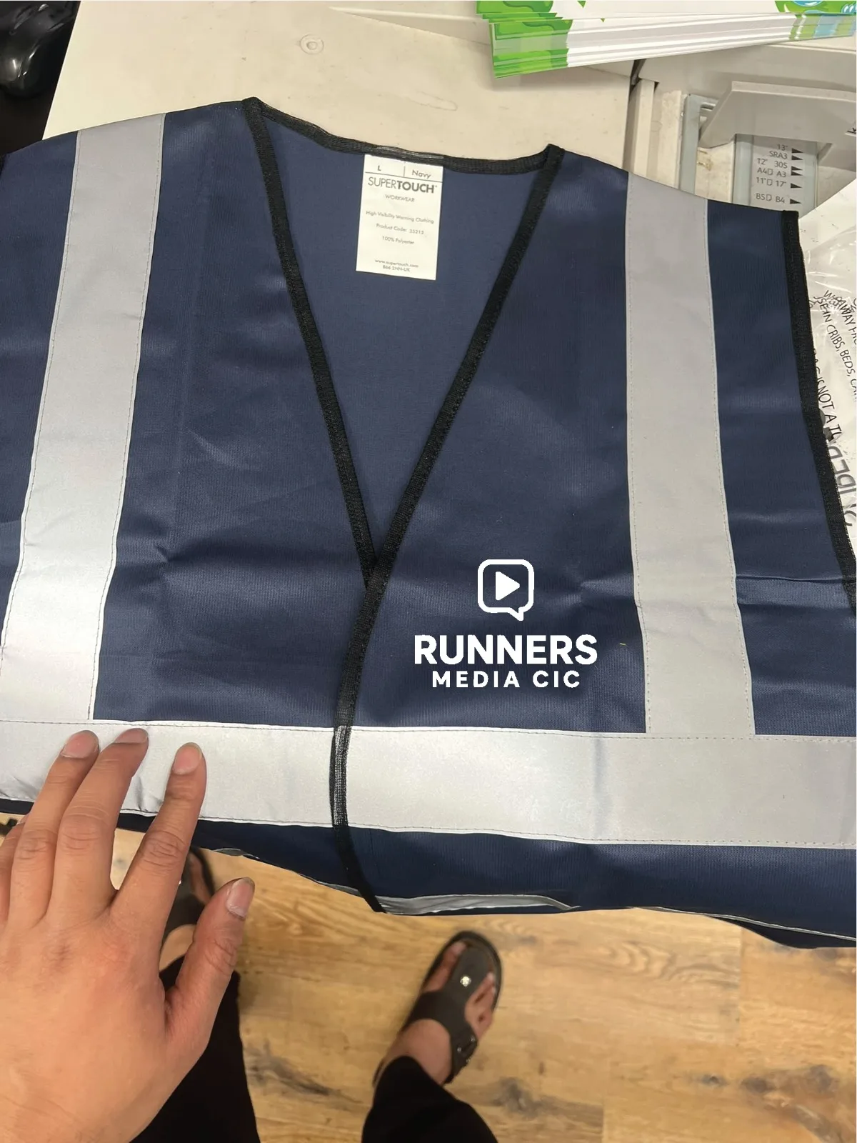 Navy hi-vis vest with custom white logo printed on the chest — real customer order printed by IT Wheel London