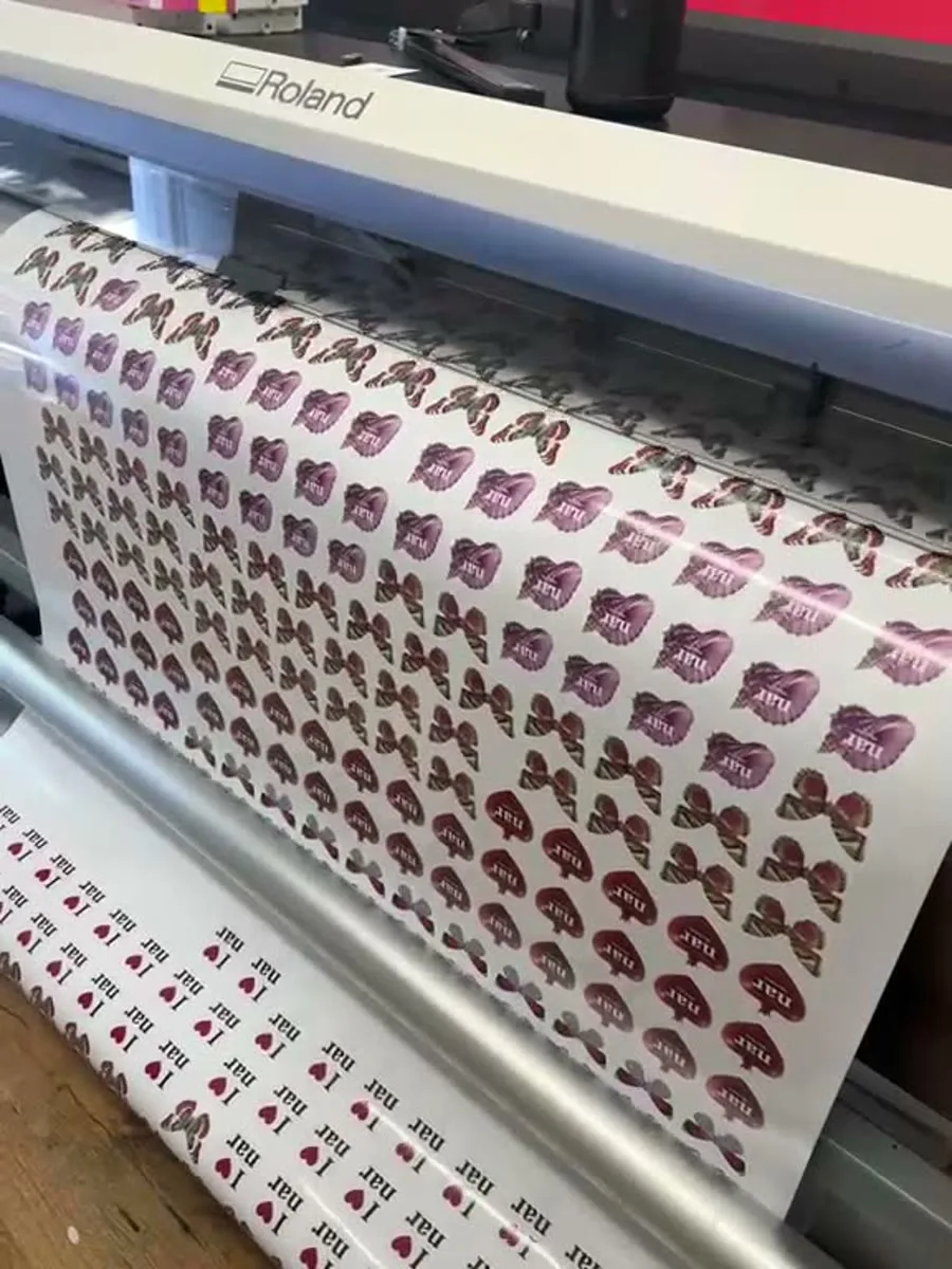 Custom vinyl stickers in production on our wide-format Roland printer
