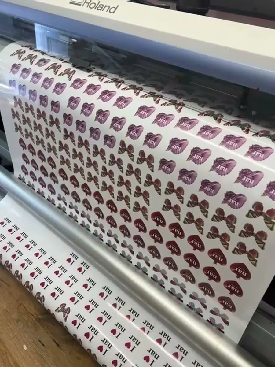 Die-cut stickers being printed and contour-cut on the Roland at IT Wheel's London E1 workshop — same-day sticker run
