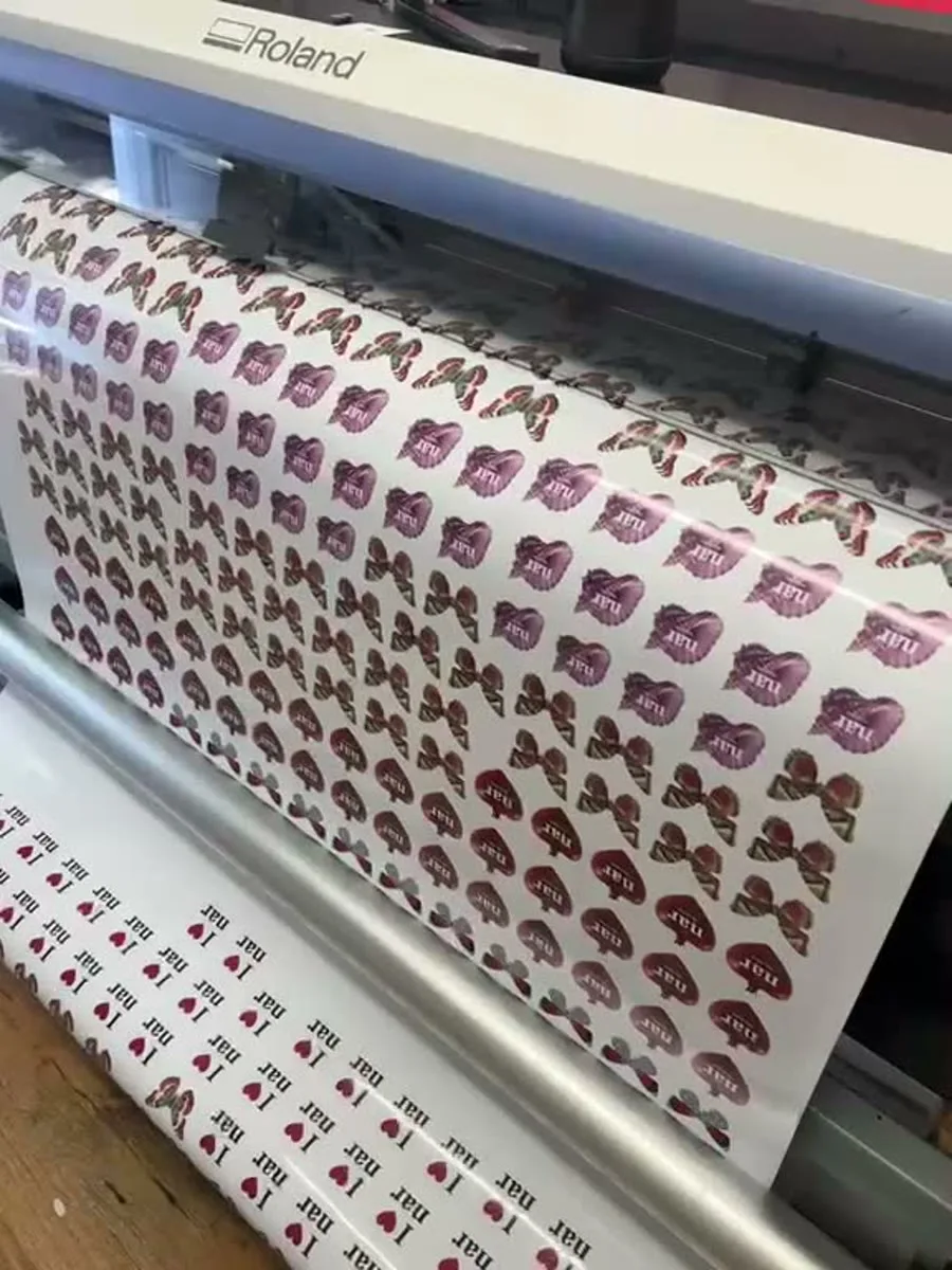 Custom sticker sheets coming off the Roland print-and-cut at IT Wheel, London
