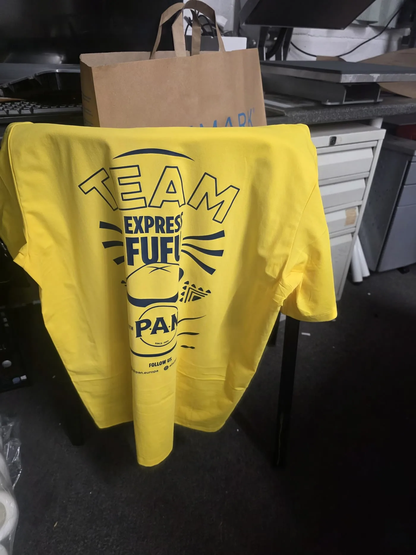 Same-day printed yellow team t-shirt with a full-colour "Team Express Fufu" P.A.N back print, made in our London E1 workshop